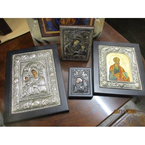 426 - A group of modern icons, some with white metal repousse decorated covers/surrounds, two stamped with... 