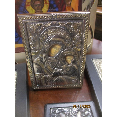 426 - A group of modern icons, some with white metal repousse decorated covers/surrounds, two stamped with... 