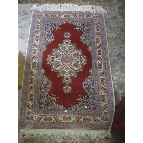 428 - A group of three Persian style rugs to include a red ground rug with central floral motif, triple gu... 