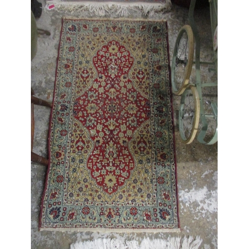 428 - A group of three Persian style rugs to include a red ground rug with central floral motif, triple gu... 