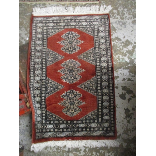 428 - A group of three Persian style rugs to include a red ground rug with central floral motif, triple gu... 