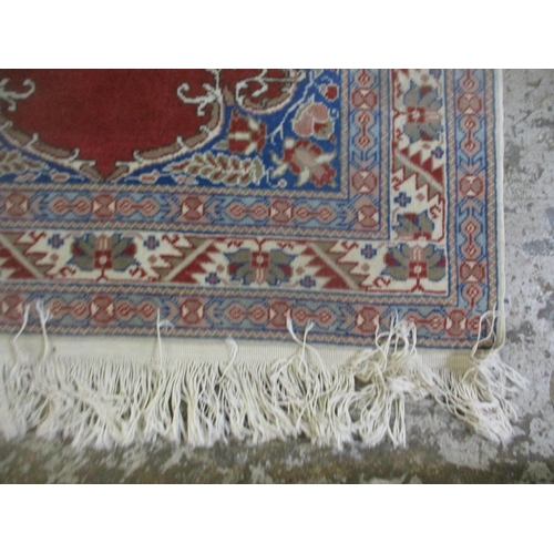 428 - A group of three Persian style rugs to include a red ground rug with central floral motif, triple gu... 