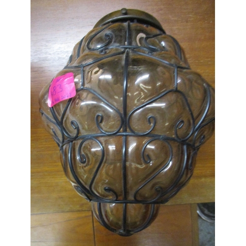 436 - A group of three Italian Seguso style glass and wrought iron caged ceiling pendant lights, one in go... 