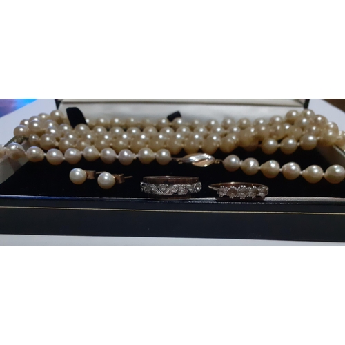 379 - A sting of simulated pearls with a 9ct gold clasp and another string of simulated pearls together wi... 