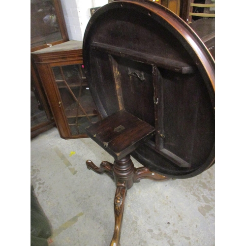 395 - An early Victorian mahogany pedestal tilt top table, circular top with moulded edge, turned column a... 