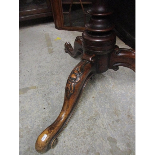 395 - An early Victorian mahogany pedestal tilt top table, circular top with moulded edge, turned column a... 