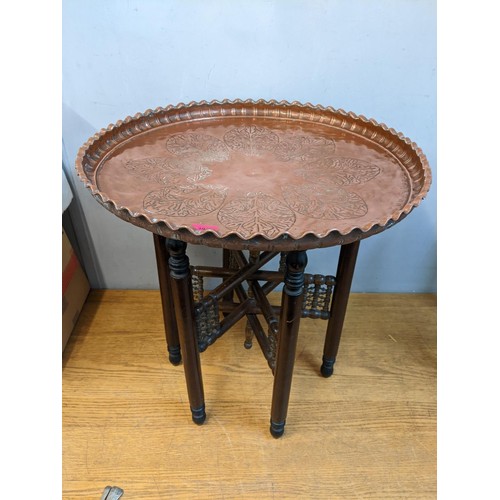 392 - Egyptian furniture to include a brass, copper and white metal table top table, on a wooden stand wit... 