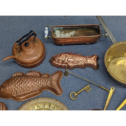 410 - Mixed metalware to include a Swiss brass and iron saucepan, copper moulds, trays and other items
Loc... 