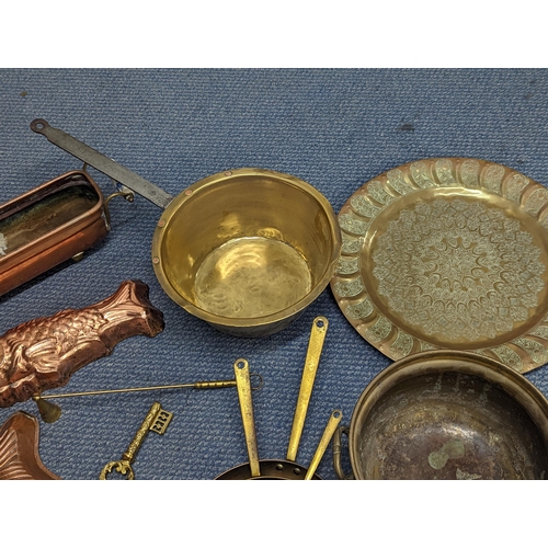 410 - Mixed metalware to include a Swiss brass and iron saucepan, copper moulds, trays and other items
Loc... 