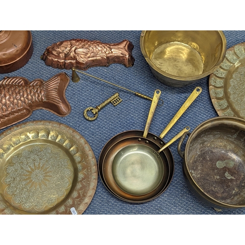 410 - Mixed metalware to include a Swiss brass and iron saucepan, copper moulds, trays and other items
Loc... 