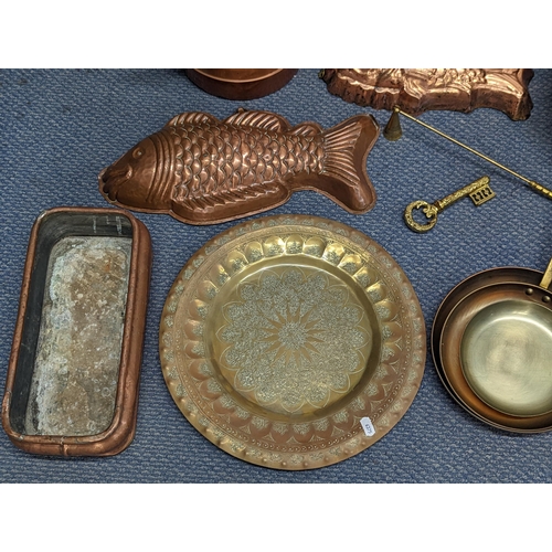 410 - Mixed metalware to include a Swiss brass and iron saucepan, copper moulds, trays and other items
Loc... 