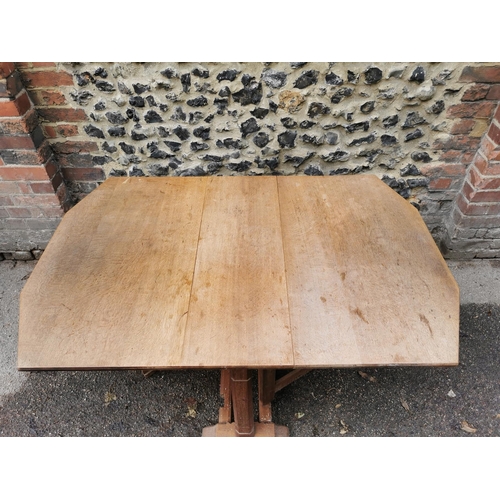 420 - A 1940s Heals oak drop leaf dining table, the leaves with canted corners, over square chamfered supp... 