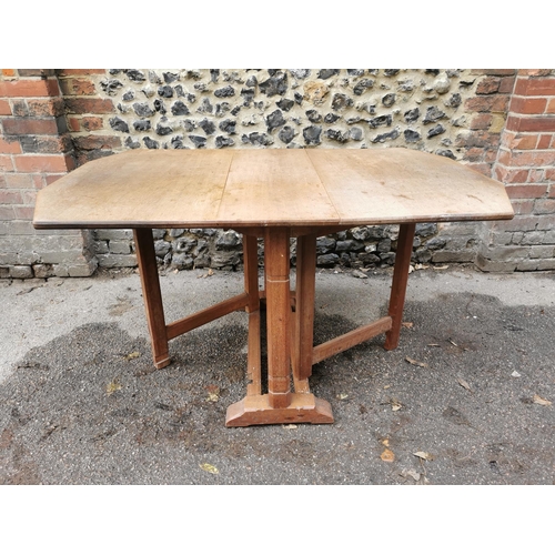 420 - A 1940s Heals oak drop leaf dining table, the leaves with canted corners, over square chamfered supp... 