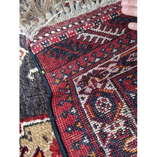 151 - A hand woven Middle Eastern red and beige ground runner having geometric designs and fringed ends, 2... 