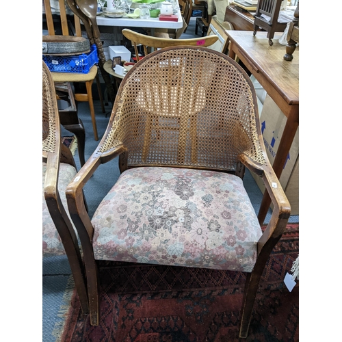 168 - A pair of early 20th century cane back armchairs with floral upholstered seats A/F Location:A2B