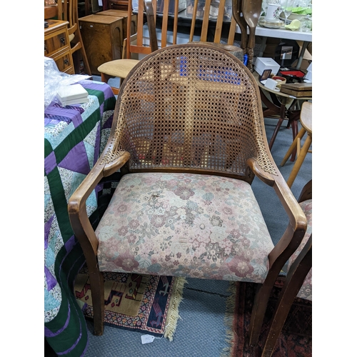 168 - A pair of early 20th century cane back armchairs with floral upholstered seats A/F Location:A2B