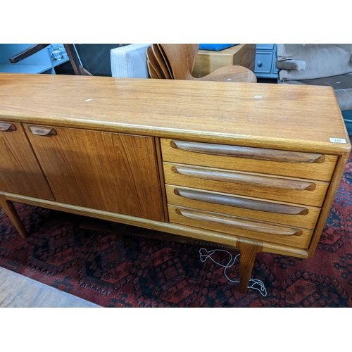 171 - A mid 20th century Younger teak sideboard having two cupboard doors and four drawers 79cm h x 167.5c... 