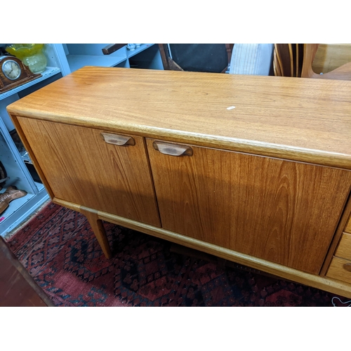 171 - A mid 20th century Younger teak sideboard having two cupboard doors and four drawers 79cm h x 167.5c... 