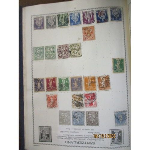 215 - An early 20th century Triumph Stamp album containing mounted world stamps including China, Straits S... 