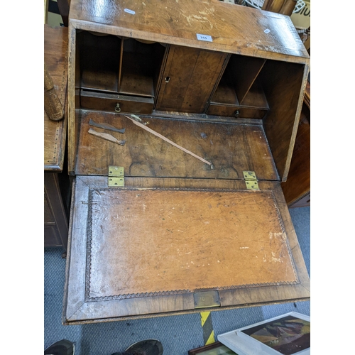 255 - A late 19th/early 20th century Georgian inspired bureau having a fall flap with fitted interior abov... 