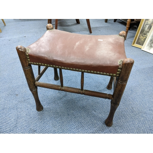 293 - Circa 1900 A stained beech 'Thebes' stool attributed to Liberty & Co having leather upholstery linke... 