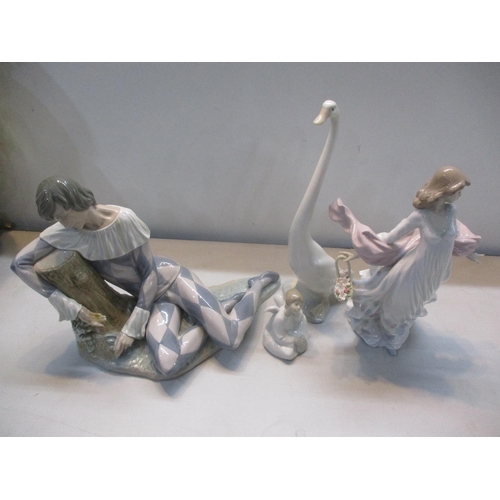 318 - A collection of Lladro and Nao to include Lladro Harlequin Reclining, Lladro figurine Spring Splendo... 