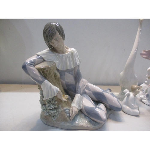 318 - A collection of Lladro and Nao to include Lladro Harlequin Reclining, Lladro figurine Spring Splendo... 