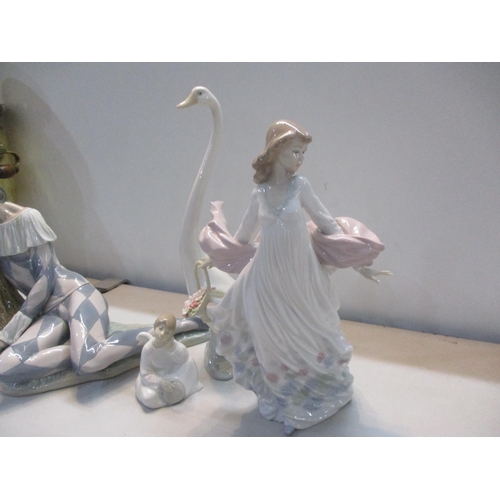 318 - A collection of Lladro and Nao to include Lladro Harlequin Reclining, Lladro figurine Spring Splendo... 