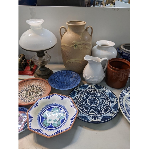 344 - A mixed lot to include two German salt glazed pots, an oil lamp, vintage wall clock, large twin hand... 