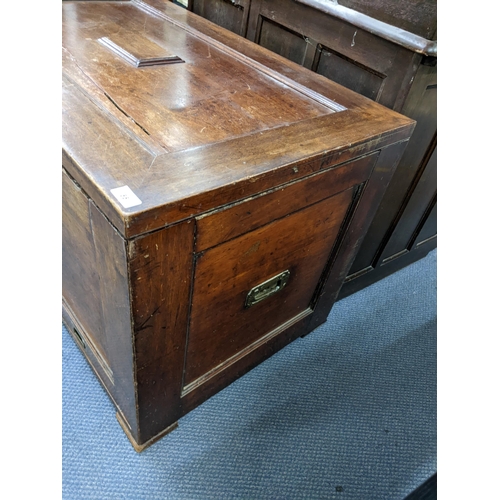 55 - An early 19th century camphor wood campaign style dower chest having a hinged top with drawer below ... 