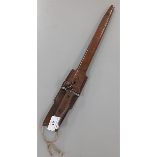 61 - An early 20th century bayonet in a leather scabbard with Mark Wilkinson 1907 to the blade Location:R... 