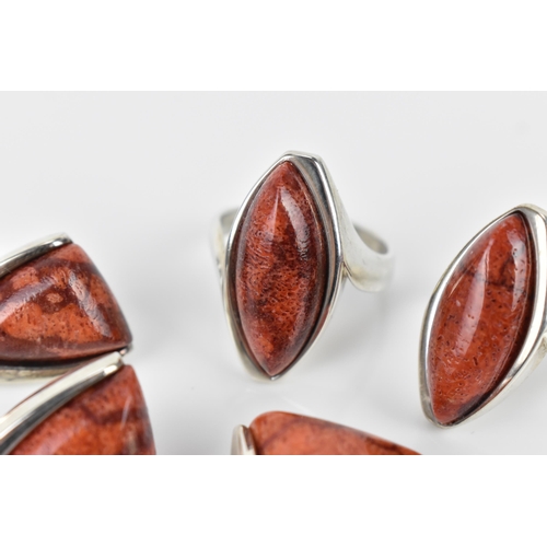 493 - A silver and red coral jewellery suite, comprising of two rings, a pair of earrings and a brooch
Loc... 