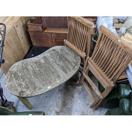 468 - Two teak folding garden chairs and a similar, low table
Location:G