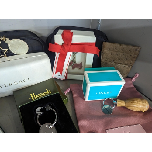 259 - Gifts to include a Linley wooden keyring, magnifying glass and letter opener boxed Radley key rings ... 