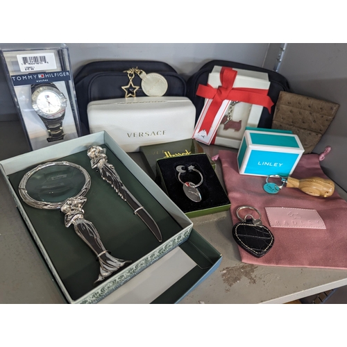 259 - Gifts to include a Linley wooden keyring, magnifying glass and letter opener boxed Radley key rings ... 