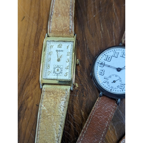 262 - A group of three wristwatches to include a silver cased 'Trench watch' style wristwatch, along with ... 