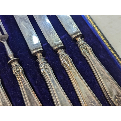 40 - A cased set of silver handled knives and forks, comprising of six knives and six forks, along with s... 