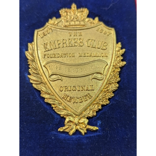 42 - A late Victorian gilt metal medallion for the Empress Club, inscribed 1837, 1897 The Empress Club Fo... 