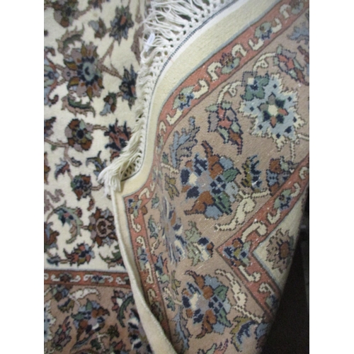 632 - Two rugs: a hand woven rug, probably Iranian, having allover floral design on a white ground, triple... 