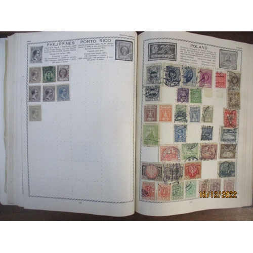 215 - An early 20th century Triumph Stamp album containing mounted world stamps including China, Straits S... 