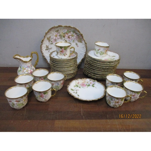 216 - A late 19th/early 20th century Limoges porcelain tea set, hand coloured floral decoration with gilt ... 