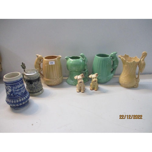 578 - A group of Sylvac jugs and pottery terrier dogs to include two squirrel jugs, a stork handled jug, a... 