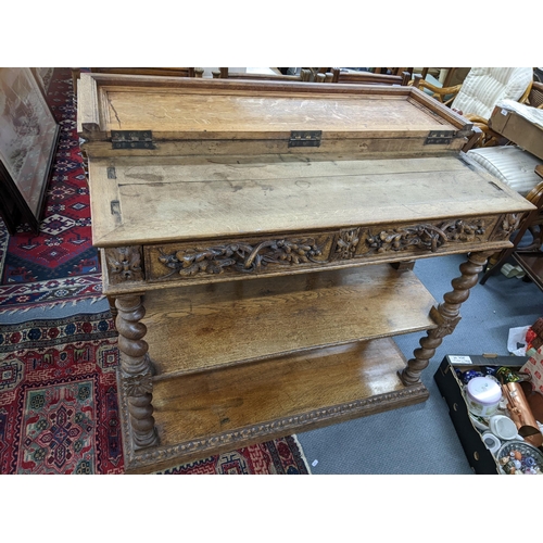 608 - A late 19th/early 20th century oak three tier buffet stand having applied carved floral handles to t... 