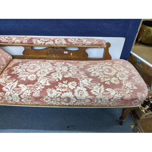 610 - A late Victorian chaise longue having a carved oak frame and on turned tapering legs, 82cm h x 175cm... 