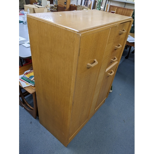 612 - A retro G-plan E Gomme bedroom dressing chest having two cupboard doors and three drawers, 121.5cm h... 