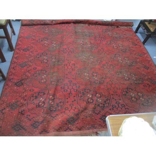 70 - A Persian hand-woven red ground rug decorated with elephant gulls and geometric floral devices, trip... 