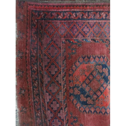 71 - A Persian hand woven red ground rug decorated with elephant gulls, multiguard border and tasselled e... 