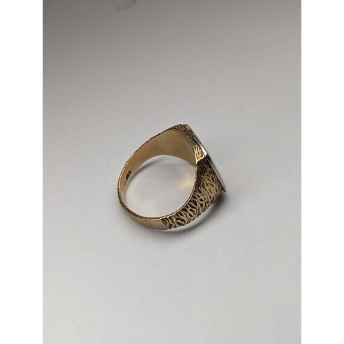 175 - A 9ct gold and white metal signet ring of textured design, inset with central diamond, approx size Q... 