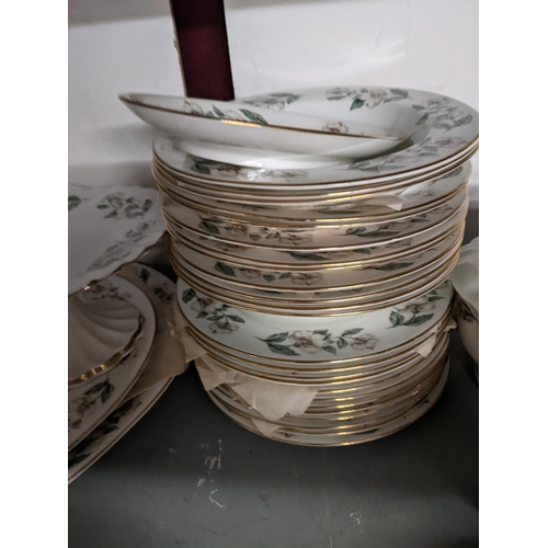 38 - A Crown Staffordshire Winter Roses pattern dinner service with tureen, plates, bowls, tea and coffee... 