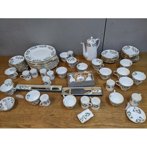 38 - A Crown Staffordshire Winter Roses pattern dinner service with tureen, plates, bowls, tea and coffee... 